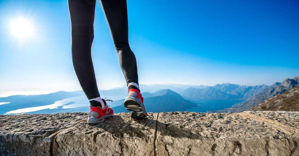 Sporty legs on the mountain hill